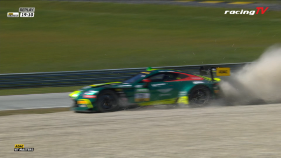 Green race car spins off track, kicking up dust during ADAC GT Masters race; RacingTV watermark visible on top-right.
