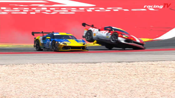 Two race cars navigate a high-speed corner; a blue-yellow car stays on track while a red-white car launches into the air after contact, near a red barrier with RacingTV logo on a race circuit.]