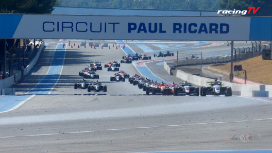 Race cars speed along a Formula circuit under a large 'CIRCUIT PAUL RICARD' banner.